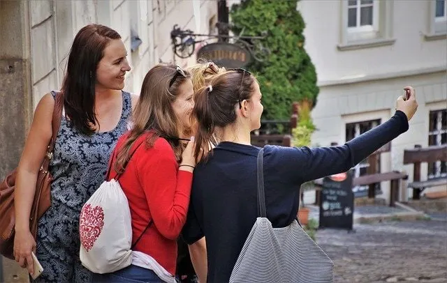 Friends taking selfie for Snapchat while traveling