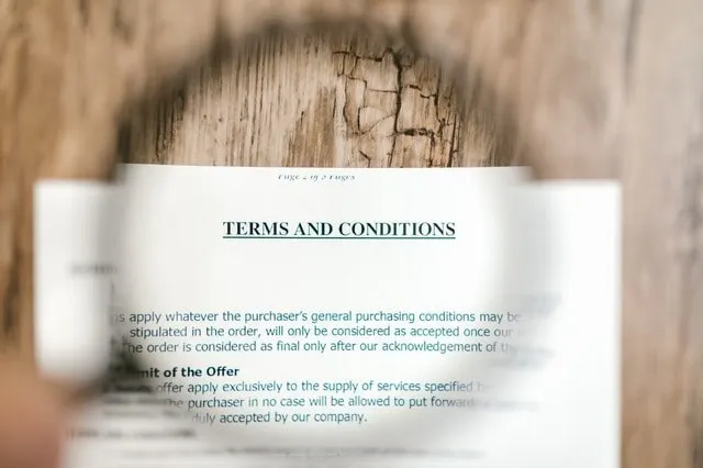 Magnifying glass over terms and conditions document 