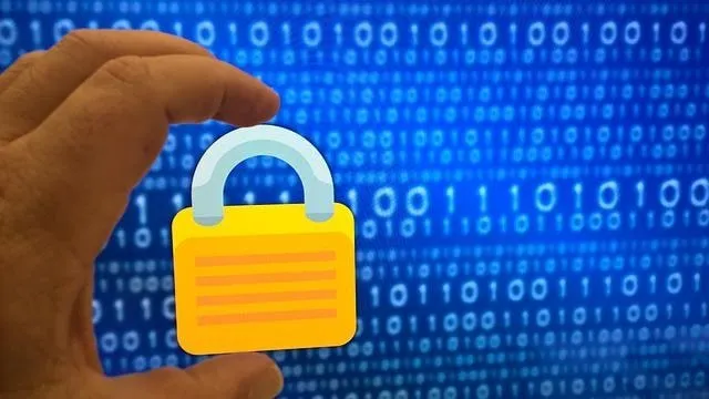 Hand holding a padlock in front of 1s and 0s