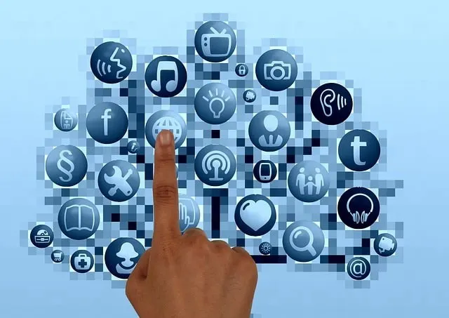 Finger touching buttons on a web of icons representing social networks