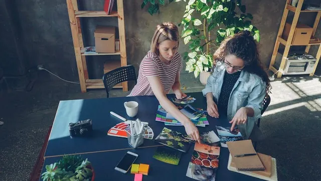 Two women reviewing photos to choose the best Instagram profile photo